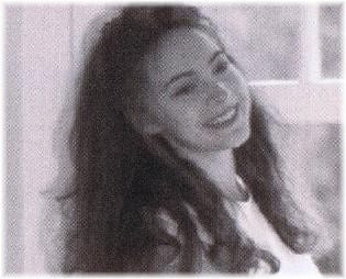 A grainy sepia portrait of Katya Grineva laughing, her hair long and dark